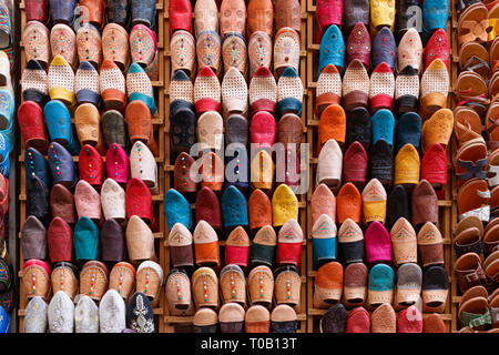 Countless colorful shoes and slippers at a souvenir shop in the medina of Fez, Morocco. Stock Photo