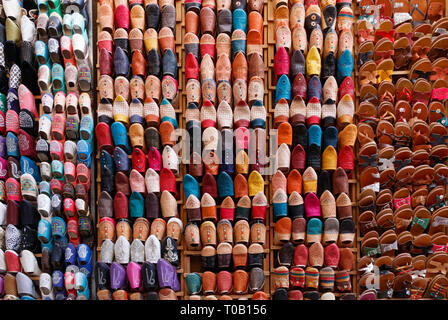 Countless colorful shoes and slippers at a souvenir shop in the medina of Fez, Morocco. Stock Photo