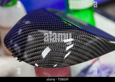 Carbon element of car gray and black in the form of weaving from Kevlar, a very durable and lightweight modern material for the production of body in  Stock Photo
