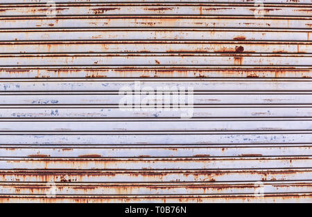 old detailed aged vintage rusty textured zinc alloy metal roller shutter door, store front exterior design used in construction industry as building m Stock Photo