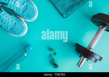 Flat lay of fitness or bodybuilding equipment on blue background. Space for copy. Stock Photo