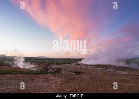 Red clay with cracks in the valley of geysers. Surprising landscape of Iceland Stock Photo