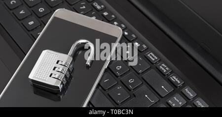 Combination lock on phone and labtop keyboard Stock Photo