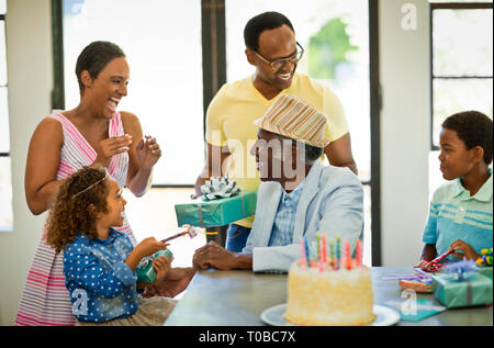 Senior man celebrating his birthday with his family. Stock Photo