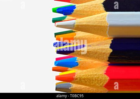 The sharp tips of the pencils. Bright colored pencils. Colored pencils on white background with selective focus. Write Your text on a white background Stock Photo