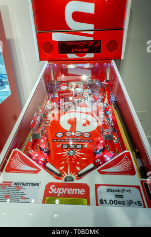 A Supreme branded pinball machine in the American Eagle store's Urban Necessities pop-up in the Soho neighborhood of New York on its grand opening day, Saturday, March 9, 2019. The pop-up features sneakers and Supreme brand street fashion from Urban Necessities, a popular sneaker resale business. (© Richard B. Levine) Stock Photo