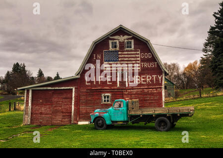 A barn located in a small town of the Palouse Region of Eastern Washington with a USA Flag and patriotic words painted on it. Stock Photo