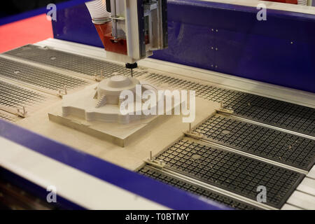CNC milling machining center in a process of cutting the injection mold part. Selective focus. Stock Photo