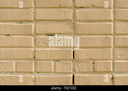 brick wall painted yellow texture Stock Photo
