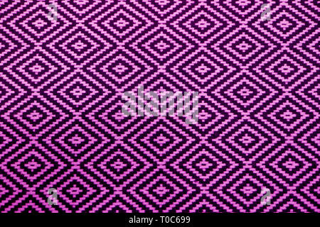 Front view of vibrant purple and black ethnic pattern fabric for background or banner Stock Photo
