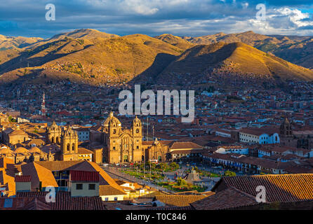 The ancient inca capital city Cusco at sunset with its Plaza de Armas square, cathedral and Compania de Jesus Jesuit church, Peru. Stock Photo