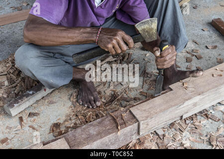 Close up of warn hands of carpenter working in traditional manual carpentry shop in a third world country. Stock Photo