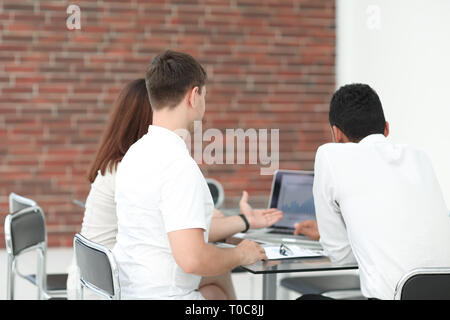 business team analyzing financial data statistics on a laptop Stock Photo