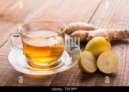 Ginger tea - Cup of ginger tea with , ginger slices on a rustic wooden background, Beverage concept, Close up focus image Stock Photo