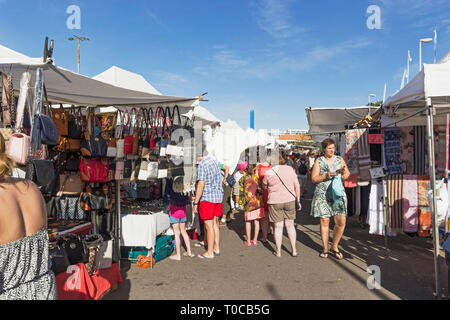 Tourist market at Costa Adeje, Tenerife with stallholders and shopping tourists. Stock Photo