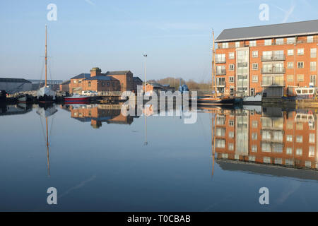 The Main Basin of Gloucester Docks with reflections in calm water Stock Photo