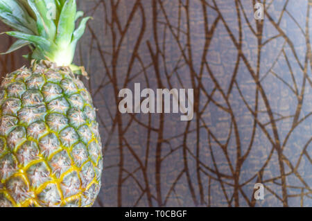 Whole pineapple fruit kept on a wooden background with copy space Stock Photo