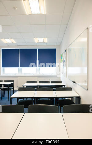 Empty classrooms at a school / college / university with desks, tables and chairs Stock Photo