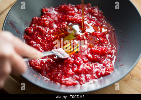 Preparing raspberry vinaigrette dressing Stock Photo