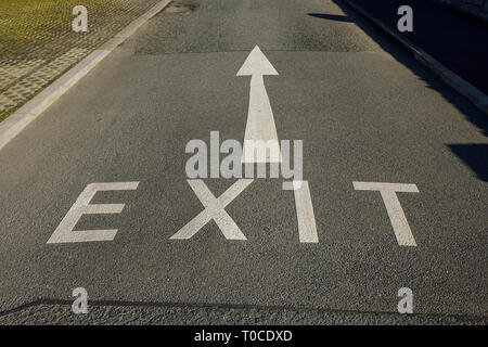 An Exit sign and arrow painted on a road in the UK Stock Photo