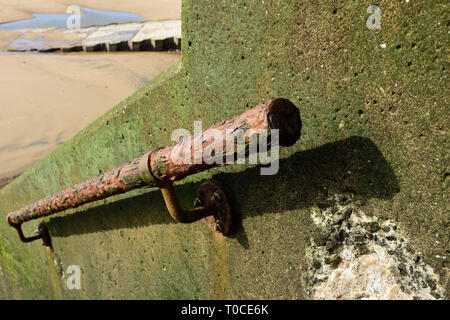Rusty steel handrail attached to green algae covered concrete sea wall, access to beach on the fylde coast in lancashire uk Stock Photo