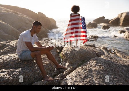 Couple relaxing on beach Stock Photo