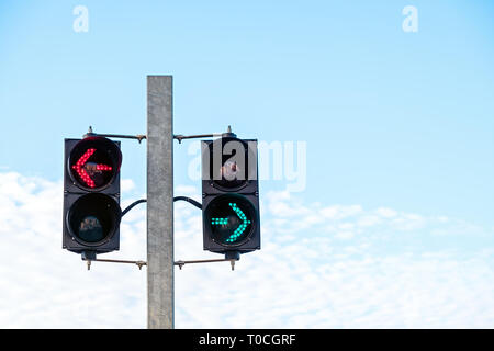 Green and red arrow safety light signals for pedestrians showing direction Stock Photo