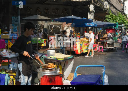 A street vendor in Chinatown, Bangkok, preparing deep-fried spring rolls Stock Photo