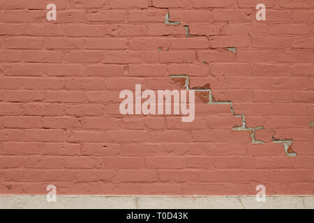 Close up of a grungy old red painted brick wall background with peeling paint Stock Photo
