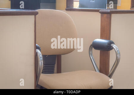 Business Executive Chair brown coloured in a small cabin space Stock Photo