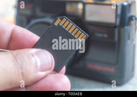 Inserting memory card into a digital camera Stock Photo