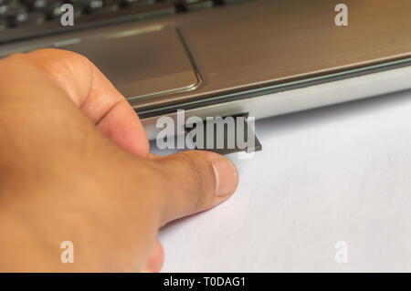 Removing memory card flash drive from a computer laptop Stock Photo