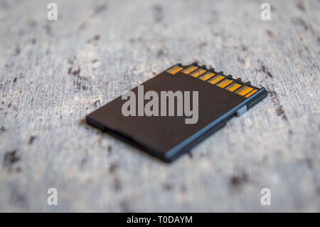 Close up of a memory card placed on a grey table Stock Photo