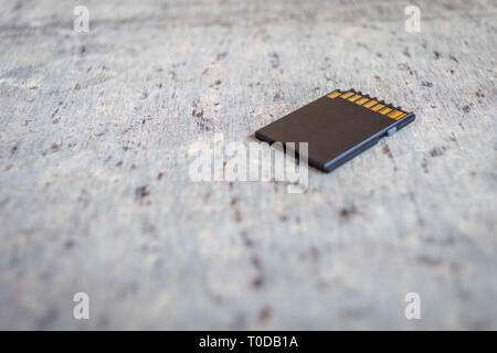 A memory card placed on a grey table Stock Photo
