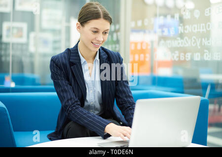 Young Office Worker using Laptop Stock Photo