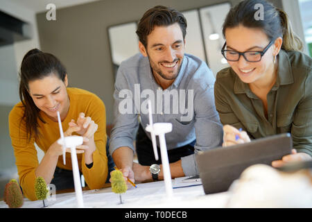 Attractive wind farm engineers looking over turbine placements Stock Photo