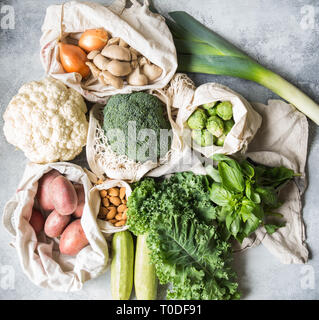 Healthy vegan ingredients for cooking. Various clean wholesome vegetables and herbs in woven bags. Products from the market without plastic. Zero wast