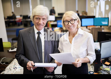 Two Mature Executives Posing in Office Stock Photo