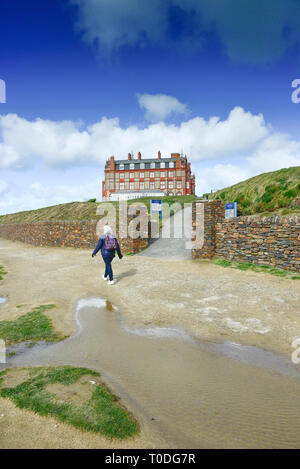 A female walker on the coastal path near the Headland Hotel in Newquay in Cornwall. Stock Photo