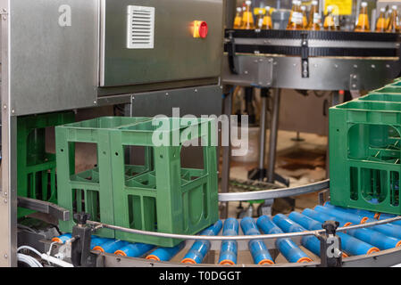 Many Crates in a row are transported to conveyor belt and moved to the filling line. Stock Photo