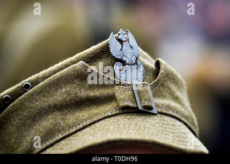 Eagle, Poland's emblem on the cap of a soldier from WWII during historical reconstruction. Stock Photo