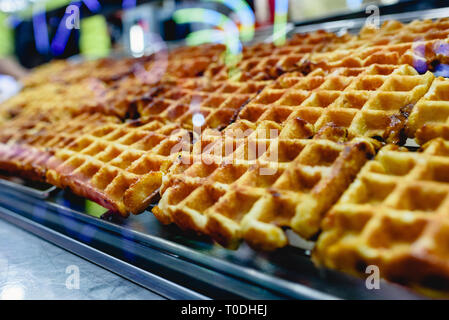 Group of freshly baked waffles ready to be savored for sale at a fair. Stock Photo