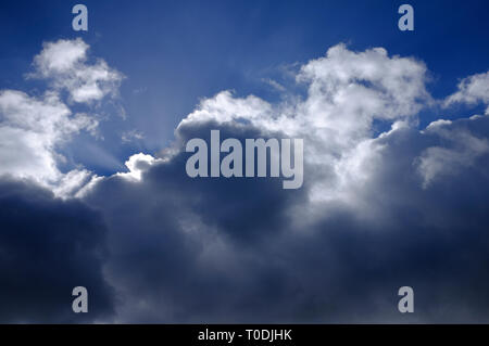 bright sun behind dark storm clouds, norfolk, england Stock Photo