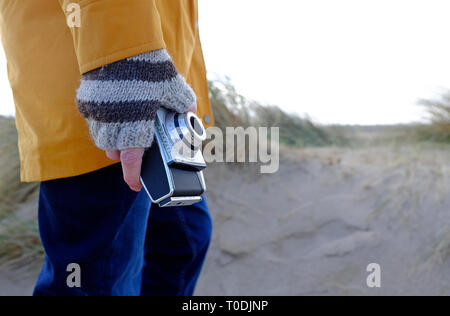 person holding retro style camera in hand Stock Photo