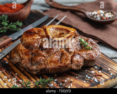 Prepared Osso buco Veal shank on a portion board closeup Stock Photo