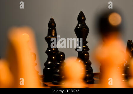 Chessboard with chess black pieces, king and queen in focus, bishop, knight, rook, pawn Stock Photo