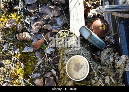Used junk, waste laying on the ground, net, container, lamp, clock Stock Photo