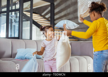 Pleased curly-haired kid standing in semi position Stock Photo