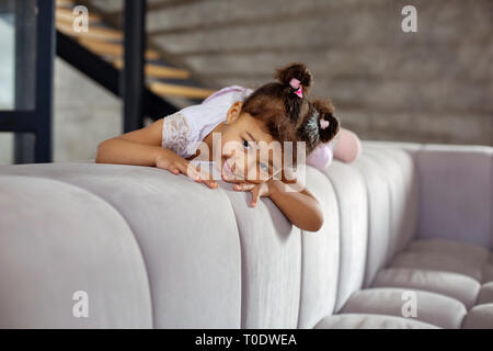 Bored little female dreaming about active weekend Stock Photo