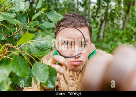 Portrait of man botanist with magnifying glass Stock Photo